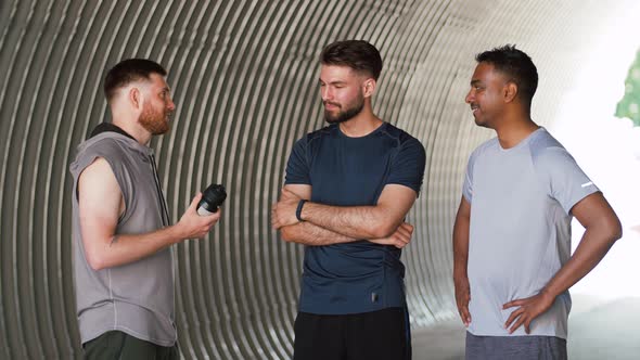 Young Sporty Men or Male Friends Talking Outdoors