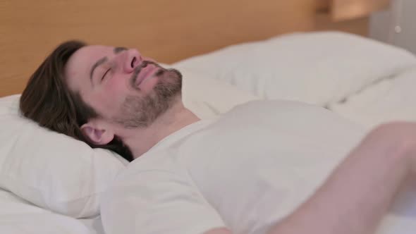 Casual Young Man Going to Bed and Sleeping