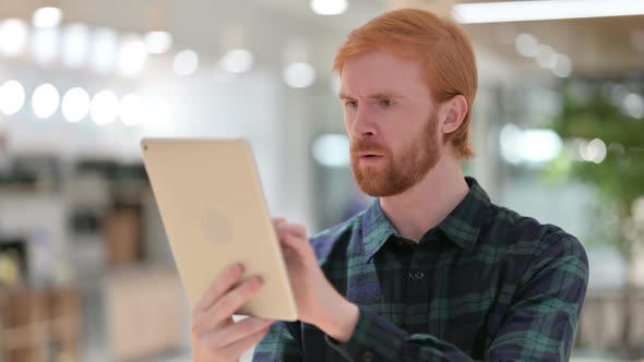 Portrait of Beard Redhead Man Having Loss on Tablet Failure