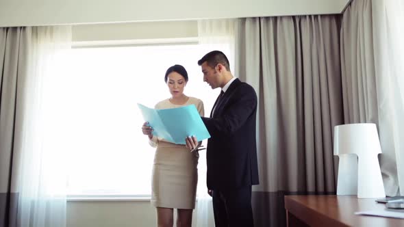 Business Team with Papers Working at Hotel Room 9