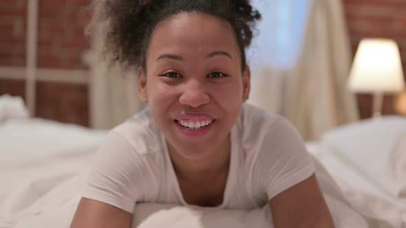 Portrait of African Woman Doing Video Call From Bedroom