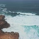 Wild ocean waves crashing againt coastal cliffs and into the caves shot by drone - VideoHive Item for Sale