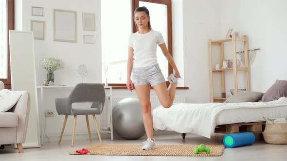 Young Fit Woman Does Morning Exercises at Home Home Fitness