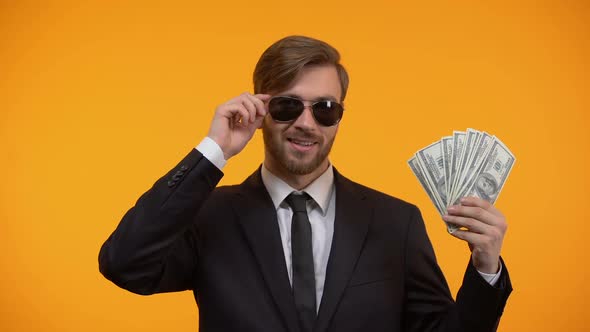 Cool Rich Man in Sunglasses Showing Bunch of Dollars and Winking, Lottery Winner