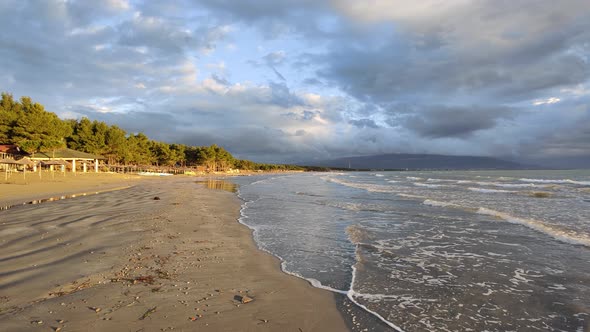 Beautiful sunset at a beach with the waves flowing