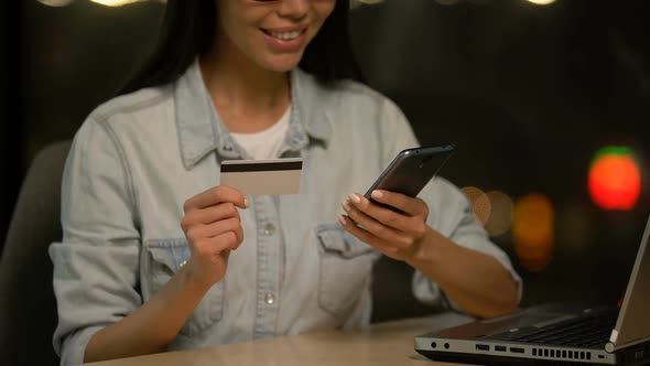 Woman Entering Credit Card Data Into Cell Phone, Easy App for Transactions