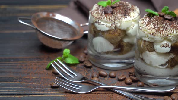 Two Portions Classic Tiramisu Dessert in a Glass on Wooden Background