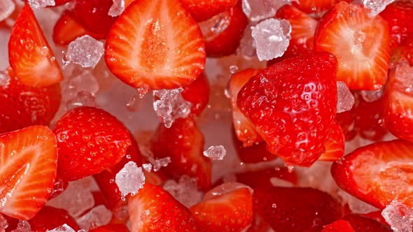 Super Slow Motion Shot of Fresh Strawberries and Crushed Ice Flying Towards Camera at 1000Fps