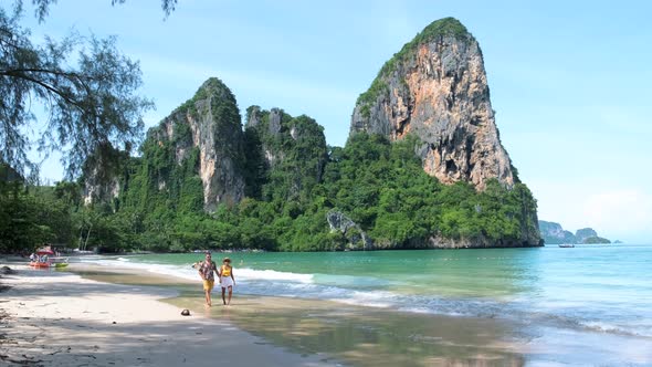 Railay Beach Krabi Thailand Couple Asian Woman and European Men Walking on the Tropical Beach of