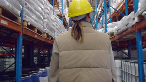 Young female worker walking in a warehouse