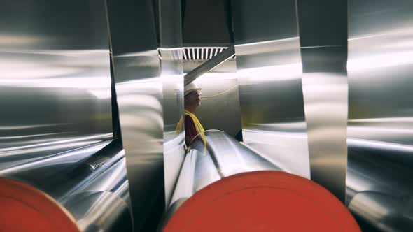 Factory Worker Is Observing Metal Panels Getting Relocated