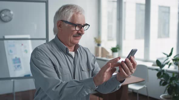 Aged Office Worker Using Smartphone
