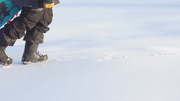 Waling Snowboarder on Slopes of Ski Resort