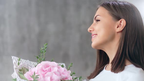Smiling Beautiful Young Girl Smelling Bouquet of Fresh Aroma Flower Having Positive Emotion