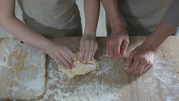 Little Girl Helping Her Grandmother to Knead Dough, Secrets of Family Cooking