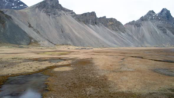 Low Flying Drone over Dramatic Iceland Mountains in Eastern Fjords Ending at Abandoned Viking Villag