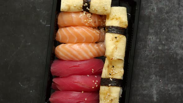 Nigiri Sushi Set in Plastic Container Ready for Takeout Delivery. Closeup of Take Away Lunch Box