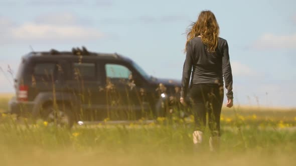 Woman Walking Toward a Modern SUV