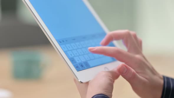 Rear View of Female Hand Using Tablet