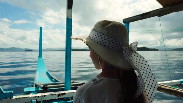 Girl in a Hat on a Boat.