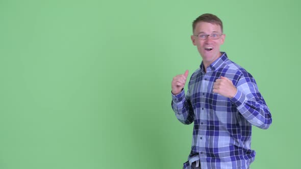 Portrait of Happy Hipster Man Snapping Fingers and Looking Surprised