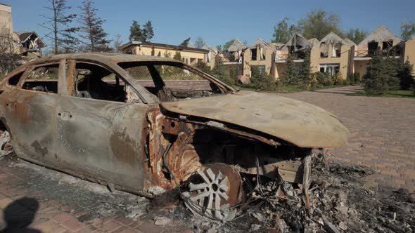 A Burnt Car and Destroyed Houses As a Result of Artillery or Rocket Fire By the Russian Army in the
