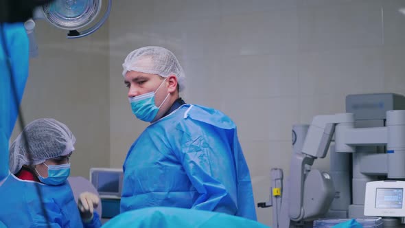 Medical nurse helps doctor to dress sterile clothing.