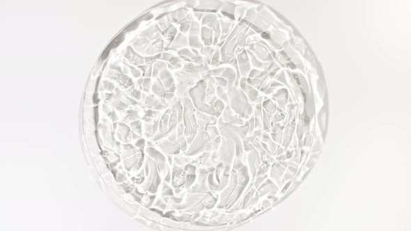 Rotation of Transparent Cosmetic Gel Fluid with Bubbles in a Glass Bowl of Petri