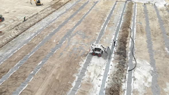 Aerial View Machinery on a Construction Site. Construction Work with the Help of Tractors and Other