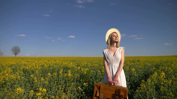 woman in white dress with suitcase and binocular