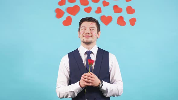 Bearded Caucasian Male with Flowers Isolated Over Blue Background