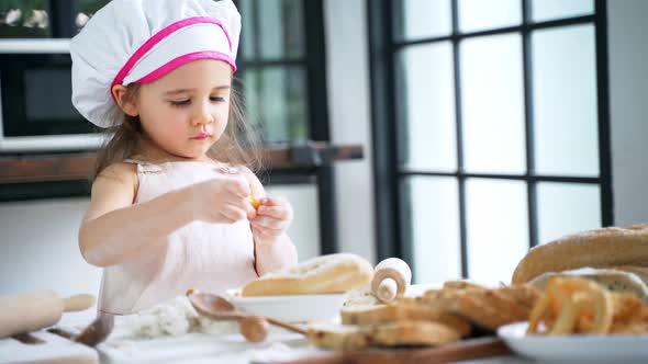 Little Girl Preparing Dough and Bake Cookies in the Kitchen While Learning in the Class at School