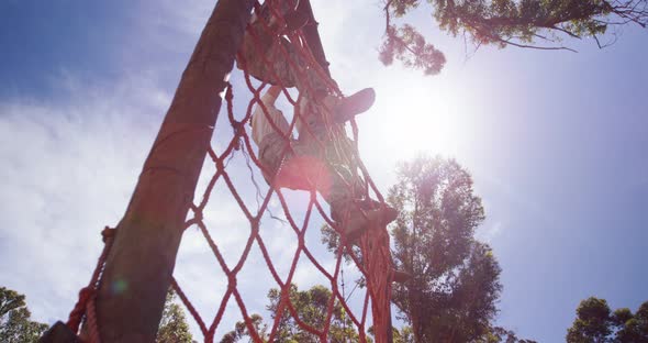 Military troops climbing a net during obstacle course 4k