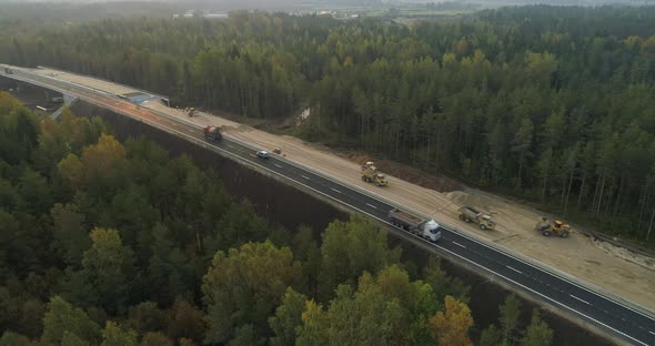 Aerial View of Road Construction Site and Cars and Trucks Driving on Highway