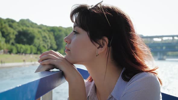 Dreamy Woman Put Her Head To Railing Looking From A Pleasure Boat On Waterfront