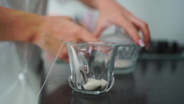 the Woman Puts Sugar and a Tea Bag in a Cup and Pours Hot Water