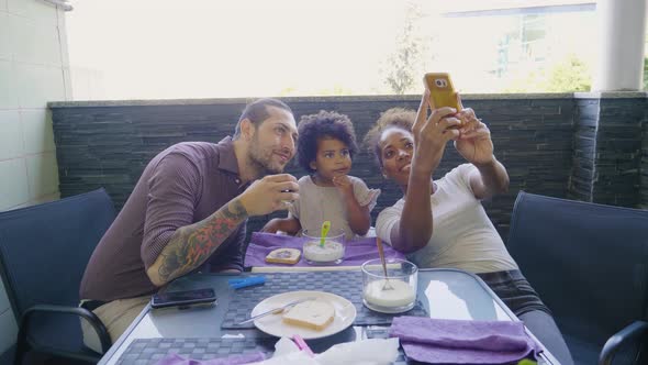 Family taking a selfie on balcony