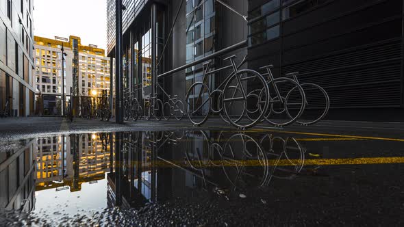 Bicycle Racks On Wet Alley At The Barcode Project In Oslo, Norway At Daytime - low level, time lapse