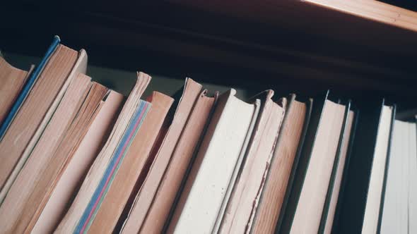 bookshelf with many old books. shelve filled with paper books.