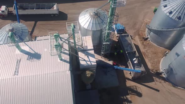 Drone aerial view of a trailer being loaded at an agribusiness that exports cover seeds located in N