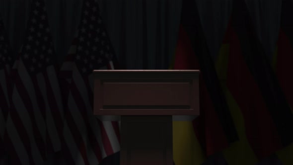 Many Flags of Germany and the USA Behind Speaker Tribune