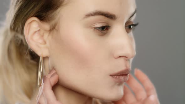 Beauty Model Touching Face Skin in Slow Motion. Close Up of Young Woman Face