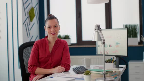 Executive Manager Sitting at Desk to Work on Business Strategy