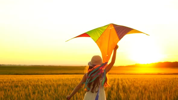 Girl Running Around with a Kite on the Field.