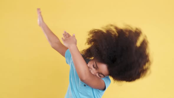 Stylish Darkskinned Multiracial Small Girl Dancing and Put Hands Up