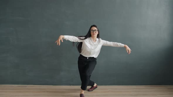 Young Pretty Asian Woman Dancing Having Fun Alone Against Black Background