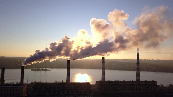 Four Pipes Smoke From Factory Chimneys on Background of Sunset Sky 007