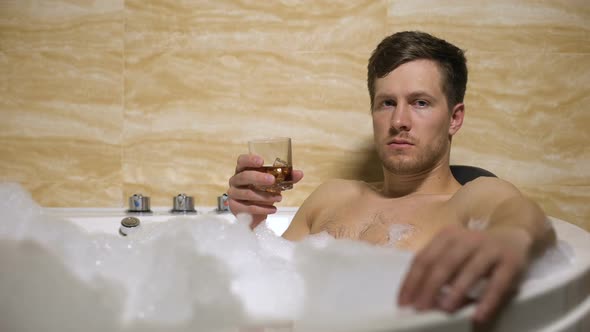 Oligarch Trying to Relax in Warm Bath, Drinking Whiskey, Thinking About Problems