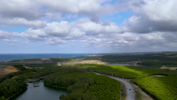 Drone flight over the north Istanbul forest. Cloudy sky, blue sea and green nature