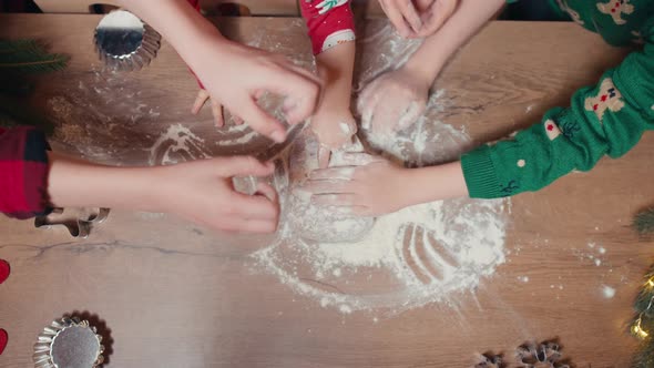 Cute Children Making Cookies with Mother on Christmas Day at Home